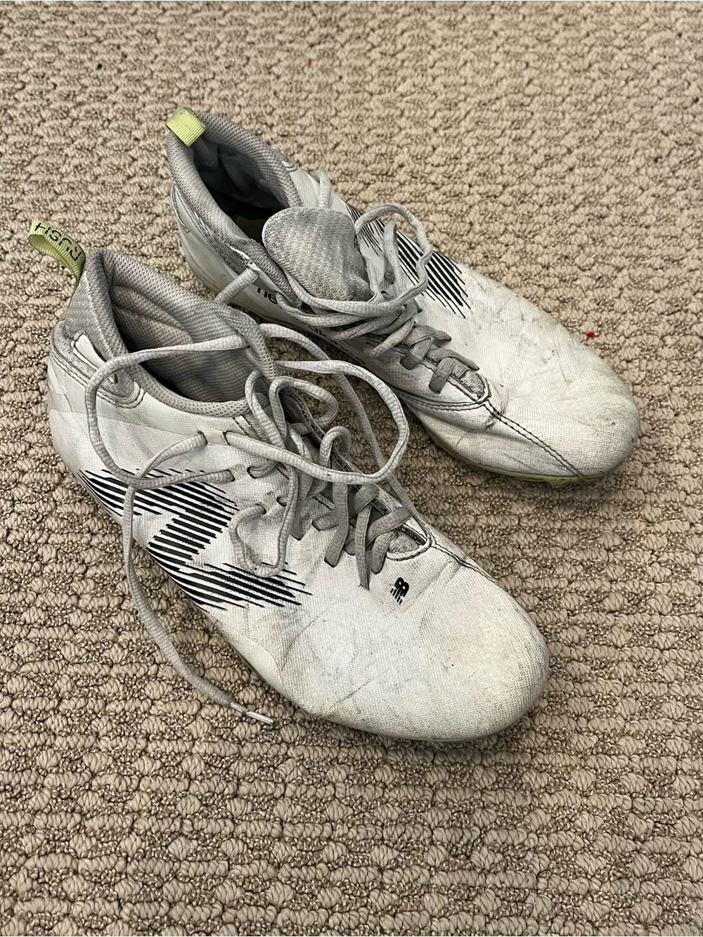 New Balance White Athletic Cleats with Black Stripe Accents